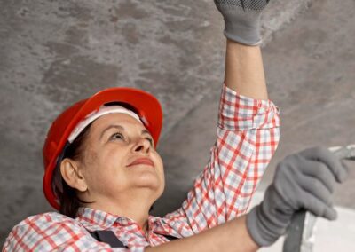 low-angle-female-construction-worker-with-helmet-gloves